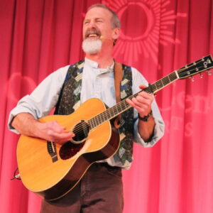 Tom Pease singer holding guitar