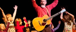 singer with guitar and children having fun