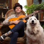man with guitar and dog