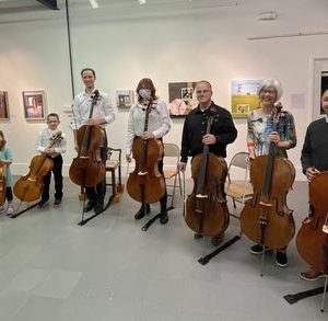musicians holding violins and cellos