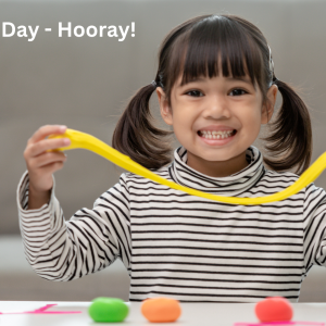 young girl holding play dough