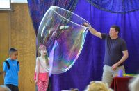 man and two children with large bubble