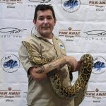 man holding large snake