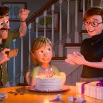 girl and parents with birthday cake with a 13 candle