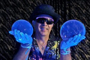 man holding a large bubble in each hand